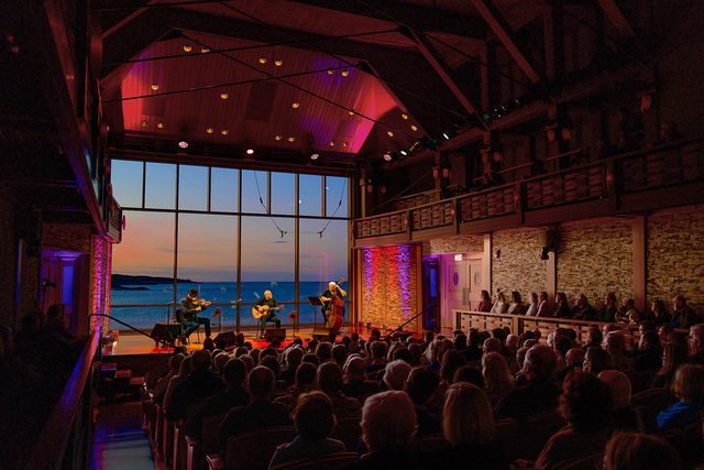 A live concert crowd at dusk.