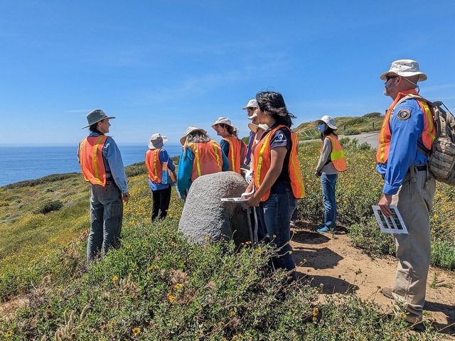 Volunteers working outdoors in a field.